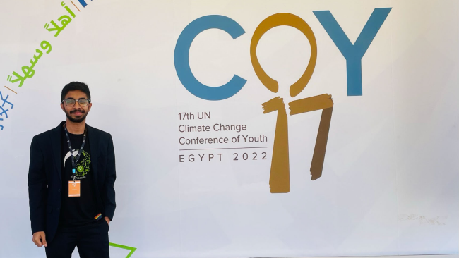Vivek standing in front of the COY17 logo